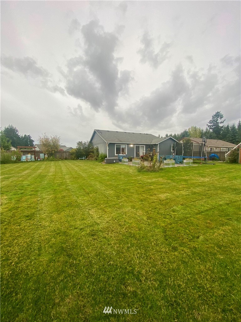 8016 188th Avenue Southwest Rochester, WA 98579 - Photo 16 of 16 a view of a large pool with lawn chairs and large trees