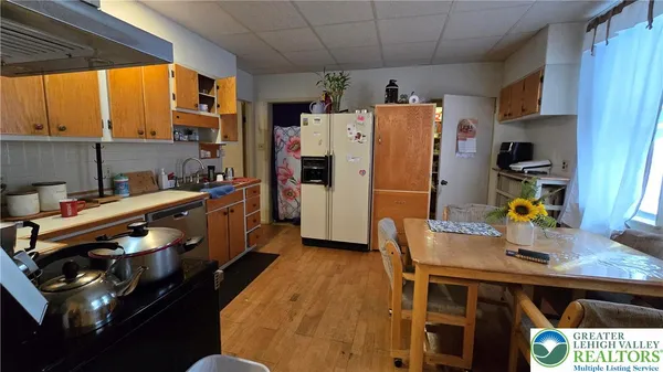 a living room with furniture a flat screen tv and a chandelier