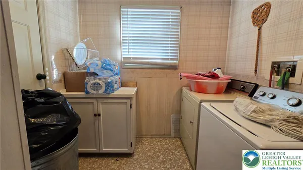 a bedroom with a bed and a flat tv screen on a dresser
