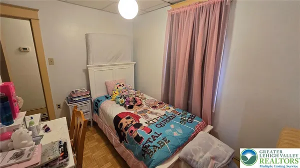 a bedroom with a bed and a mirror