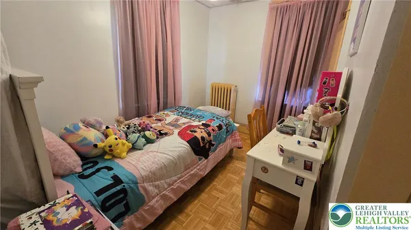 a bedroom with a bed a mirror and dresser