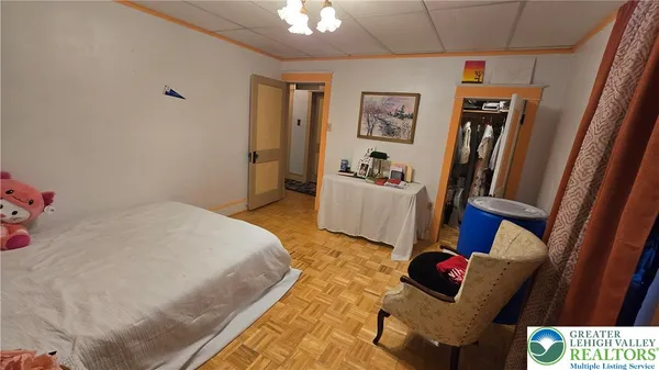 a room with water heater and wooden cabinets