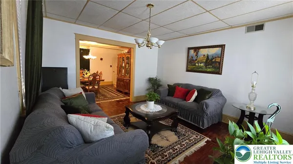 a living room with furniture and a chandelier