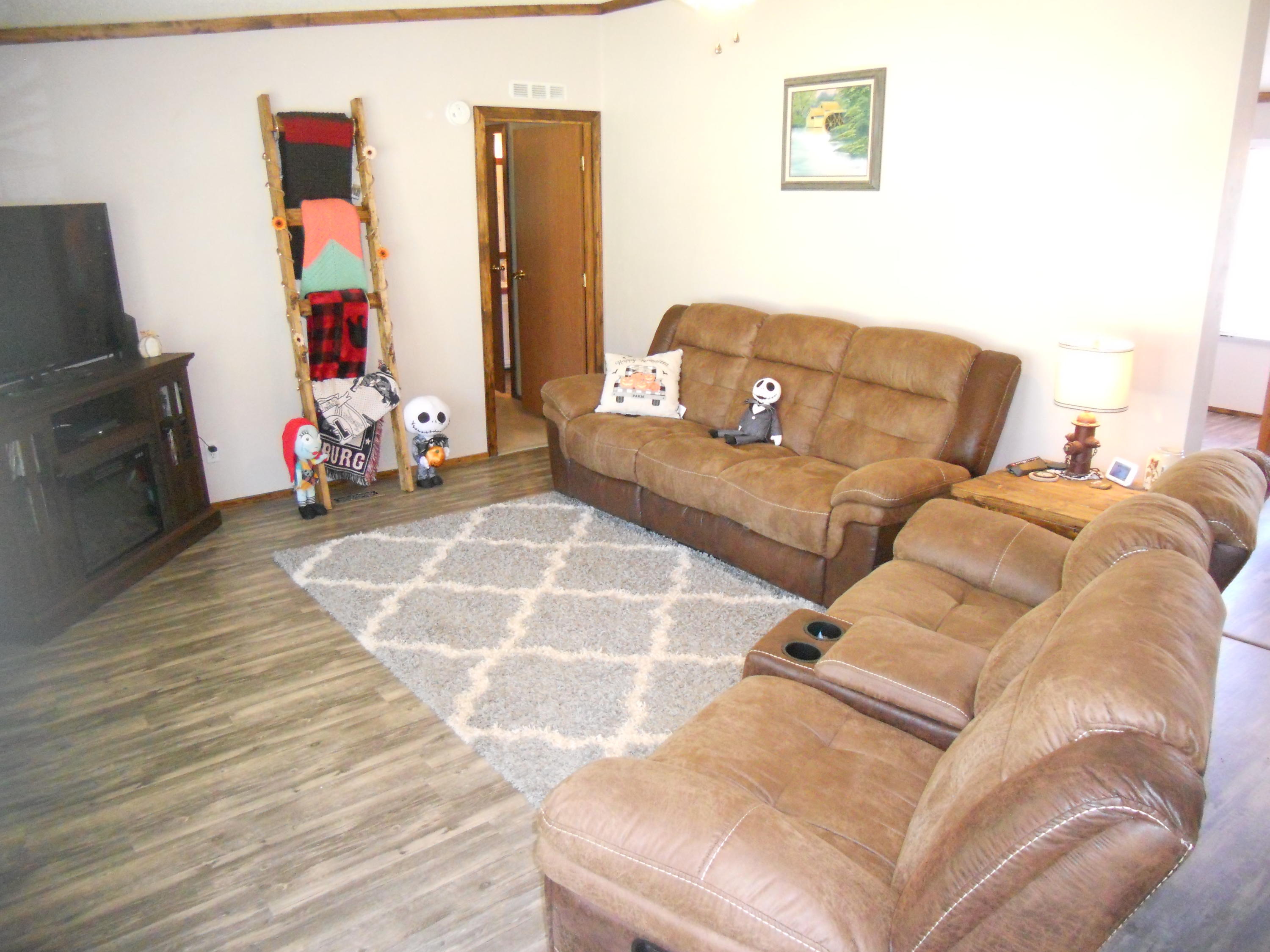 1504 Turner Branch Road Goodview, VA 24095 - Photo 13 of 64 a living room with a couch and a flat screen tv