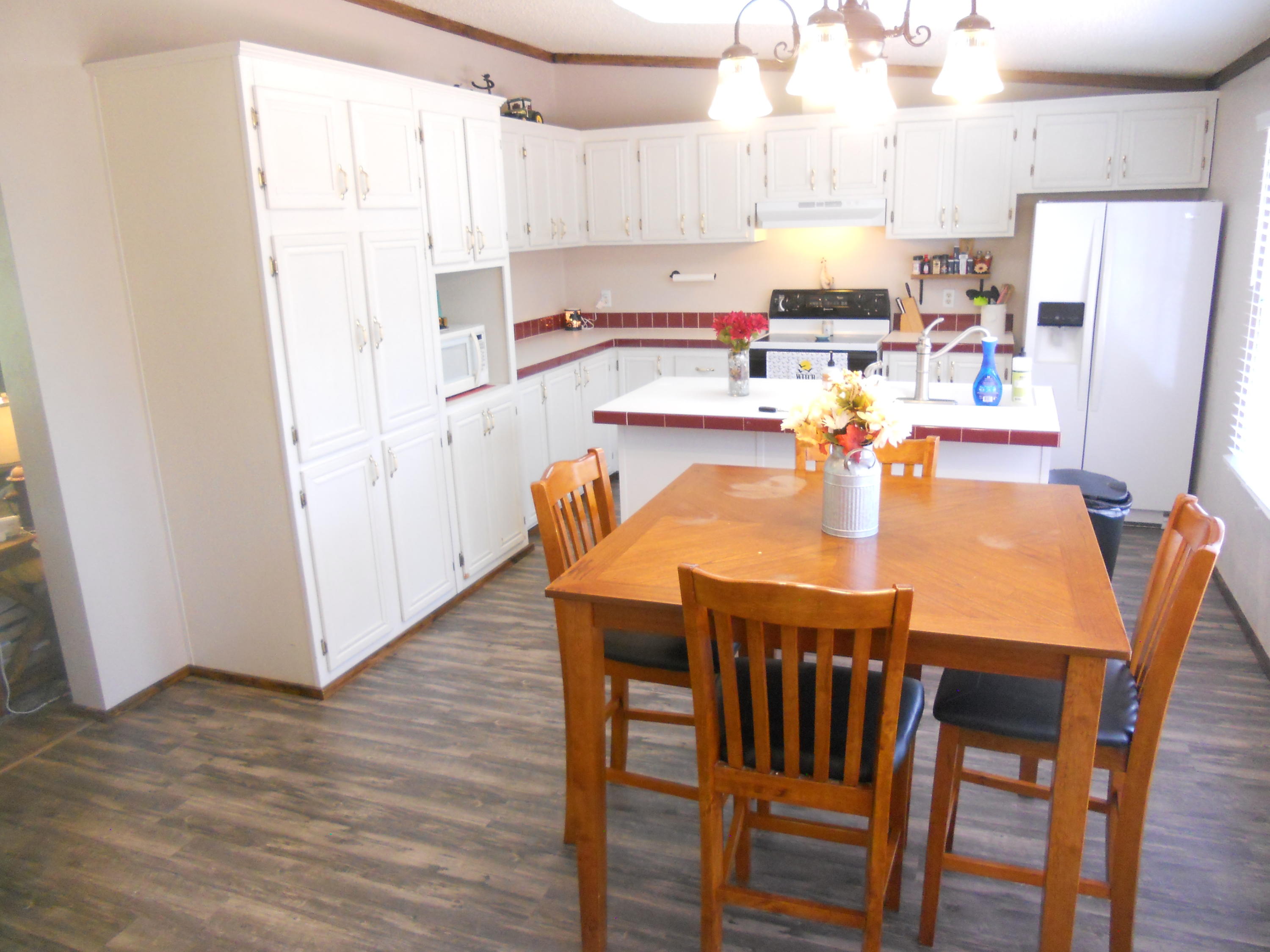 1504 Turner Branch Road Goodview, VA 24095 - Photo 17 of 64 a kitchen with a table chairs and refrigerator
