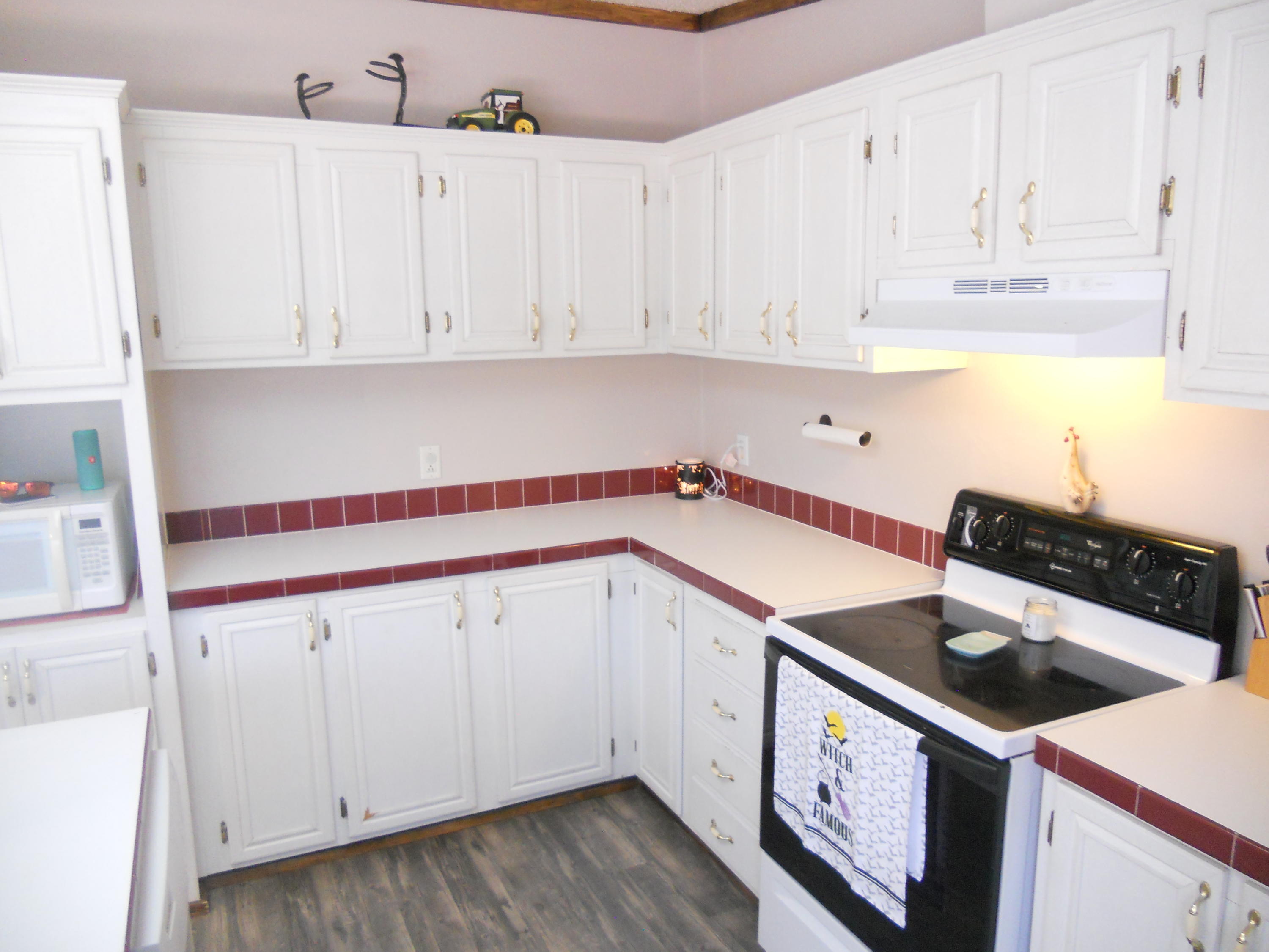 1504 Turner Branch Road Goodview, VA 24095 - Photo 21 of 64 a kitchen with granite countertop white cabinets and white appliances