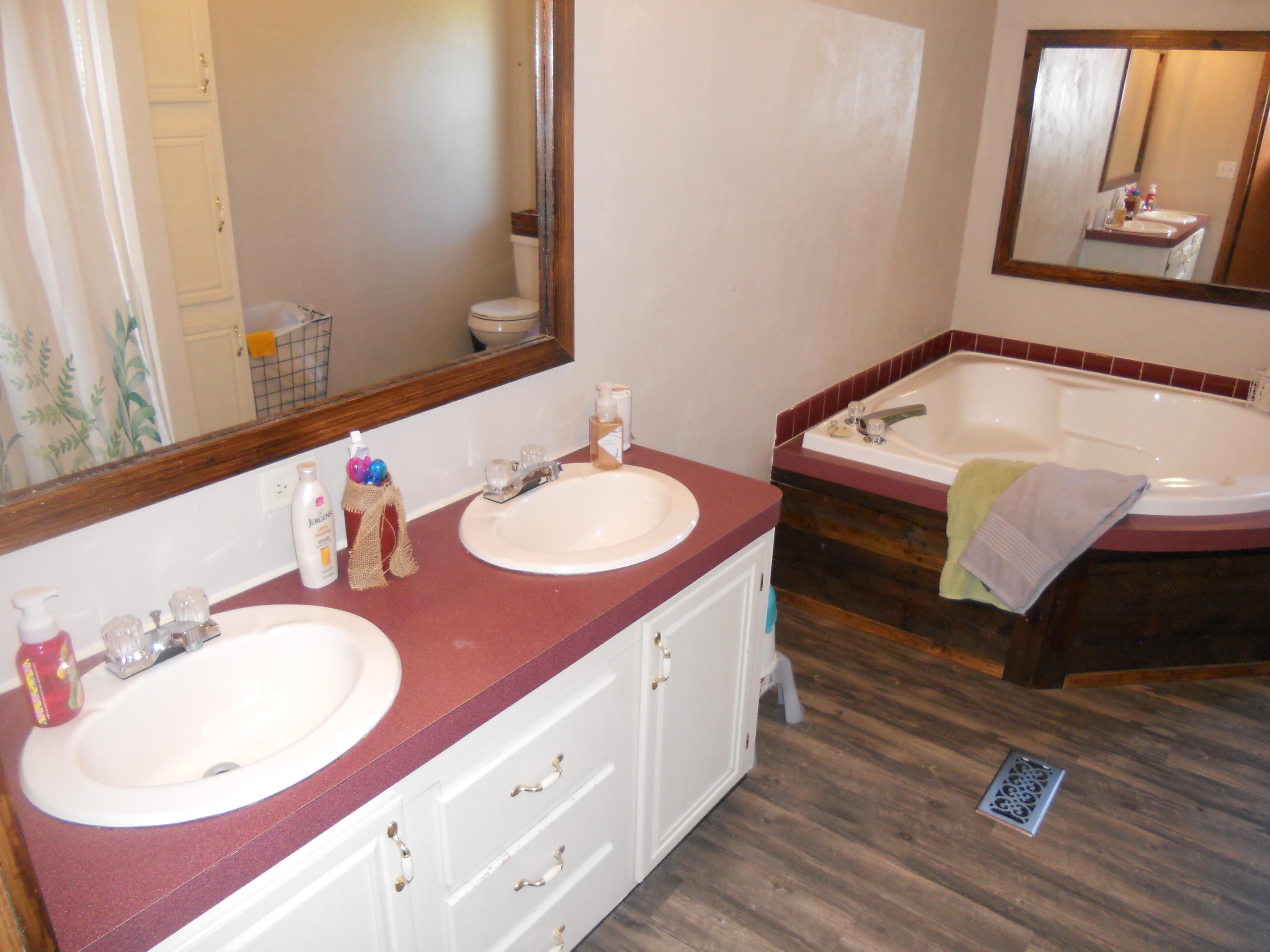 1504 Turner Branch Road Goodview, VA 24095 - Photo 34 of 64 a bathroom with a sink double vanity and a mirror