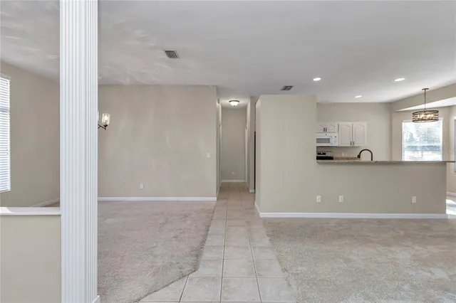 a view of a room with window ceiling fan and windows