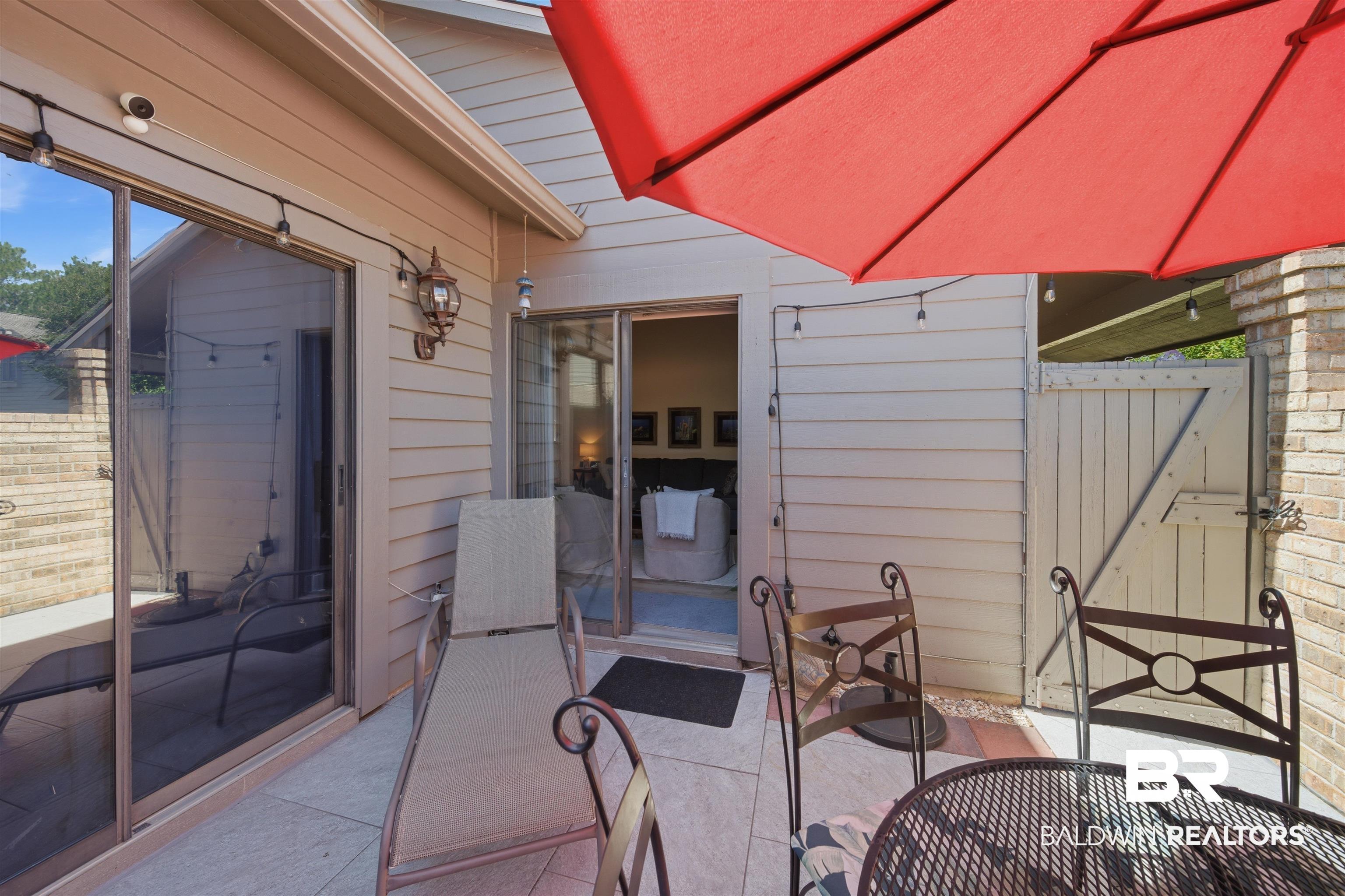 389 Clubhouse Drive, Unit 5H Gulf Shores, AL 36542 - Photo 12 of 43 Private patio with access from the living area and primary bedroom