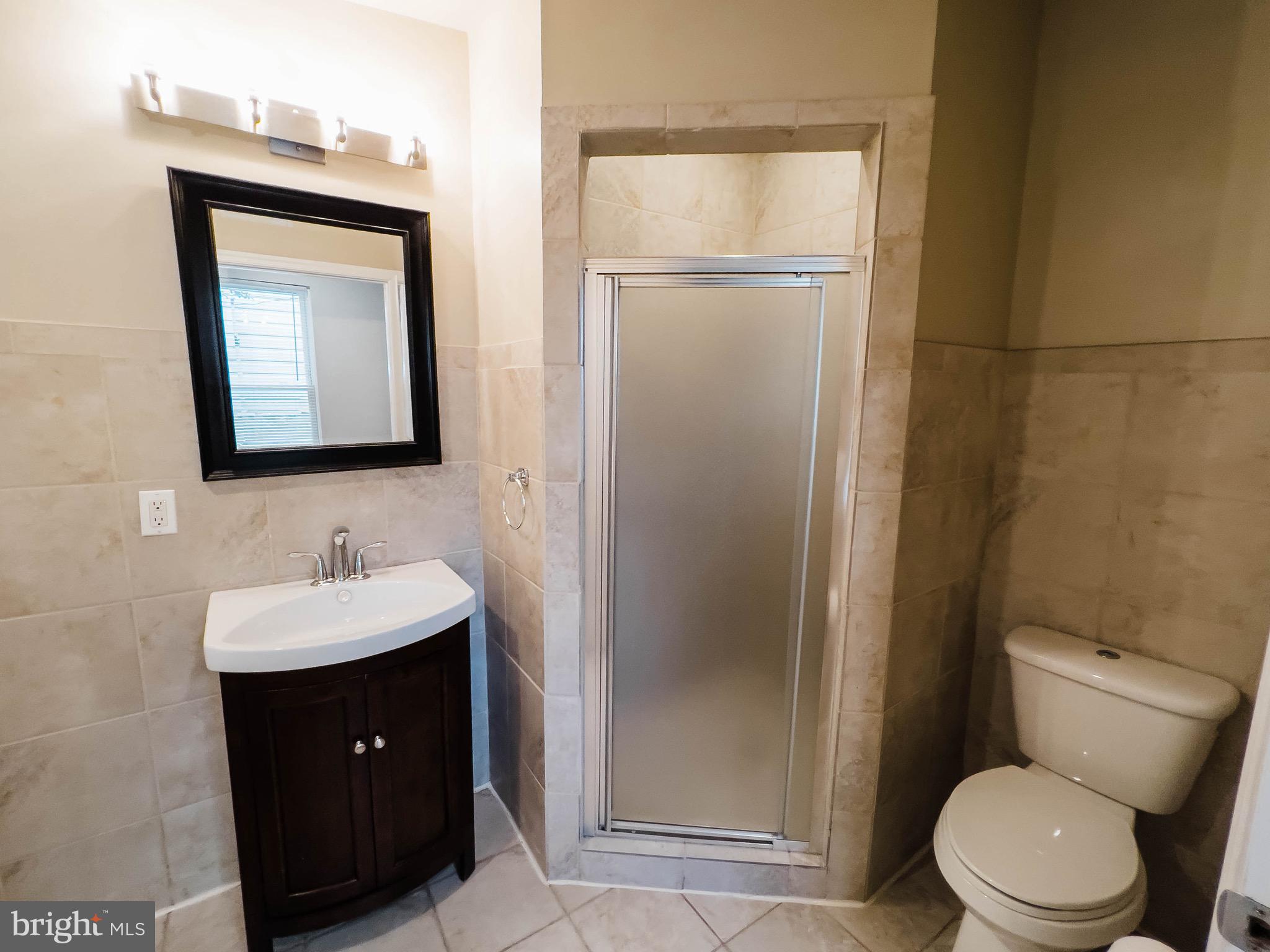 721 South Milton Avenue Baltimore, MD 21224 - Photo 14 of 23 a bathroom with a toilet sink vanity and mirror
