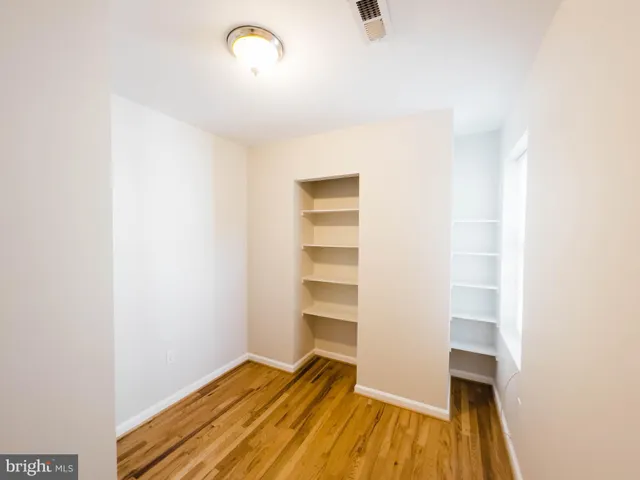 a view of room with wooden floor