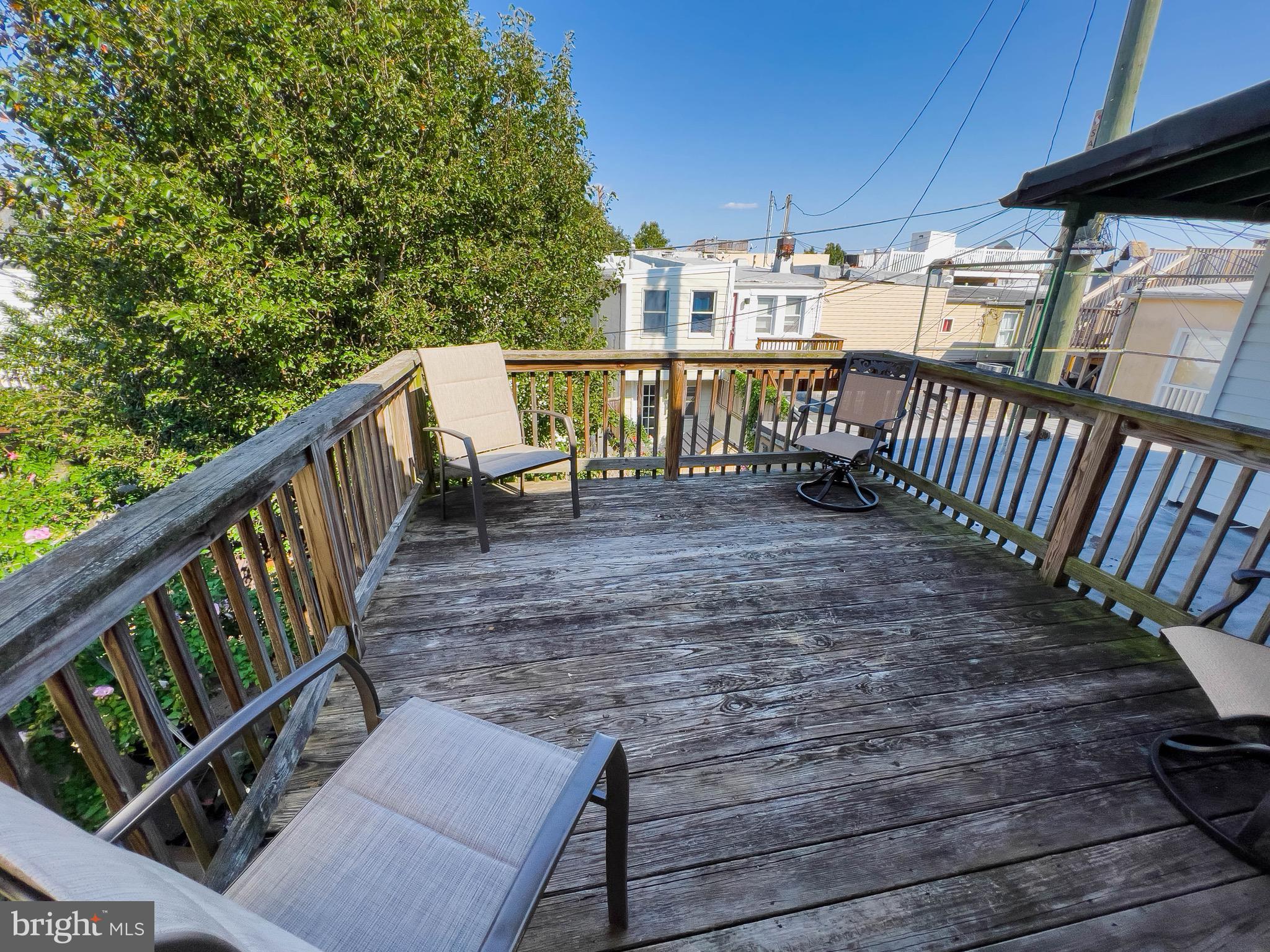 721 South Milton Avenue Baltimore, MD 21224 - Photo 22 of 23 a view of deck with furniture and trees