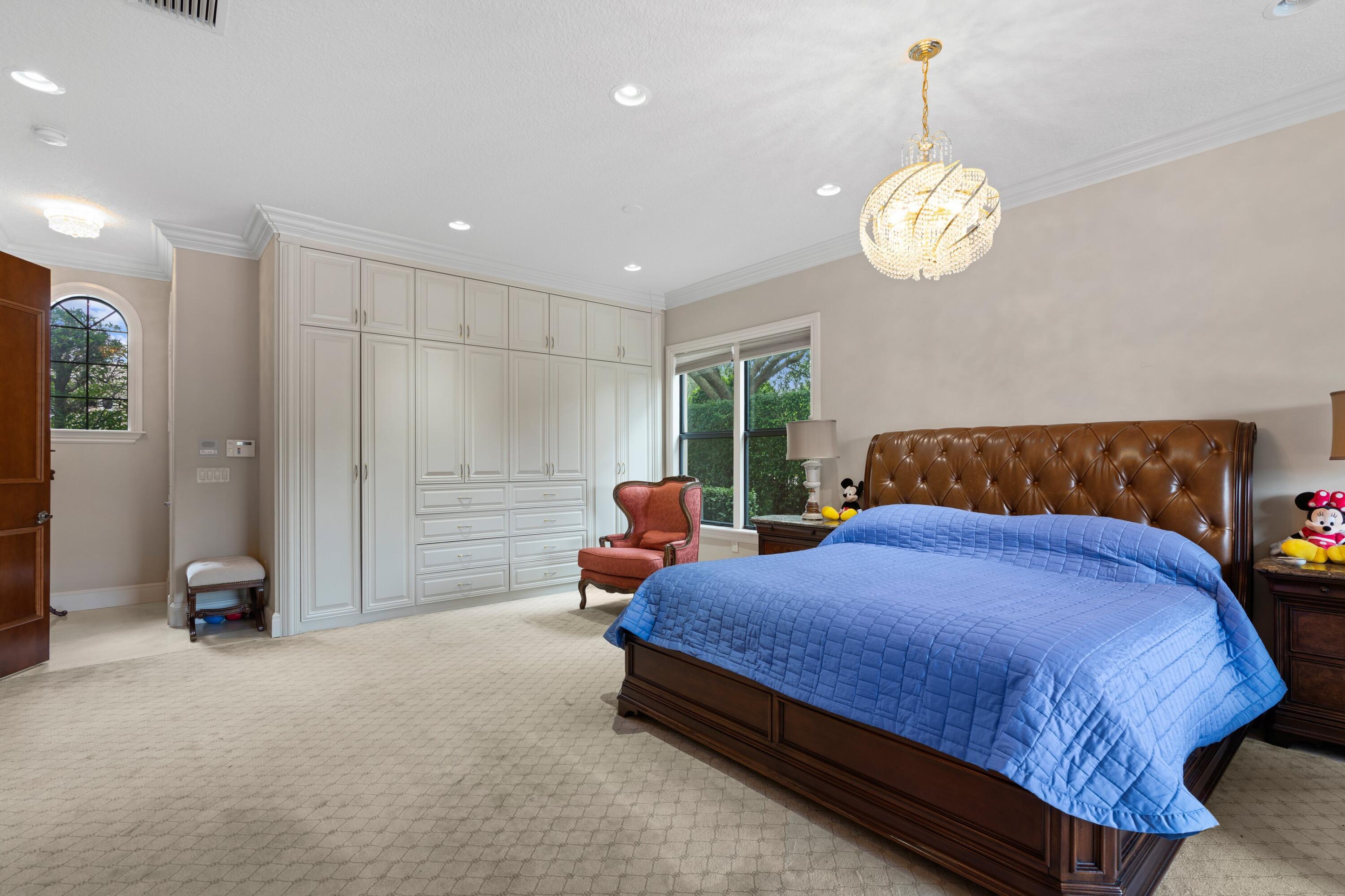 9932 Equus Circle Boynton Beach, FL 33472 - Photo 9 of 26 a bedroom with a bed and a chandelier