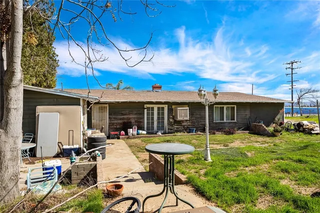 a view of a patio with table and chairs under an umbrella