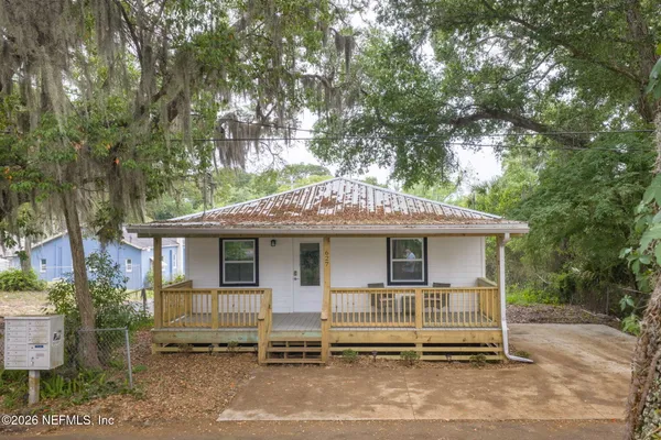 a house that has a tree in front of it