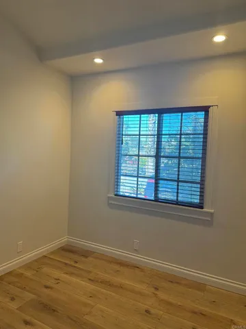a view of walk in closet with wooden floor