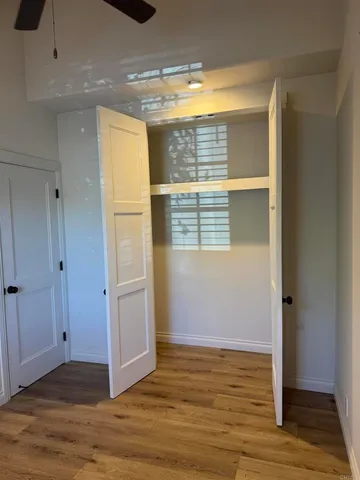 a bathroom with a granite countertop sink and a window