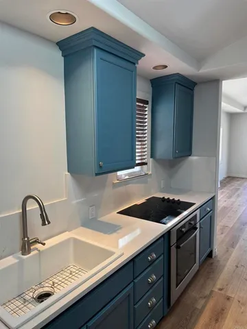 a kitchen with stainless steel appliances granite countertop a sink counter space and cabinets