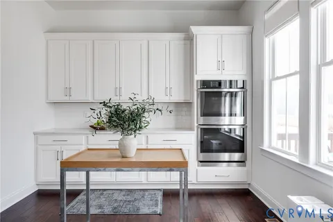 a kitchen with stainless steel appliances a stove a microwave and cabinets