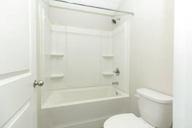 a bathroom with a toilet and a bathtub