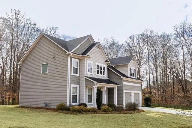 a front view of a house with a garden