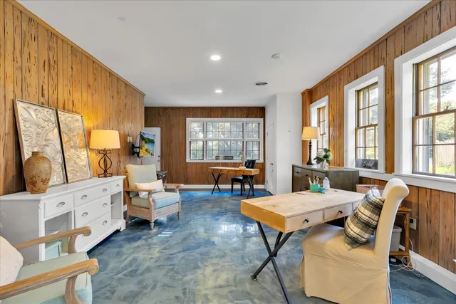 a living room with furniture and large windows
