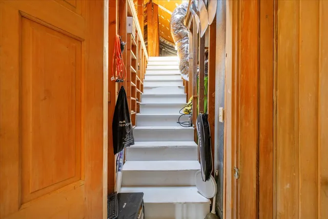 a view of staircase with wooden walls and a window