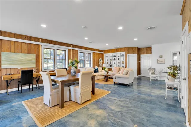 a living room with lots of furniture and a wooden floor