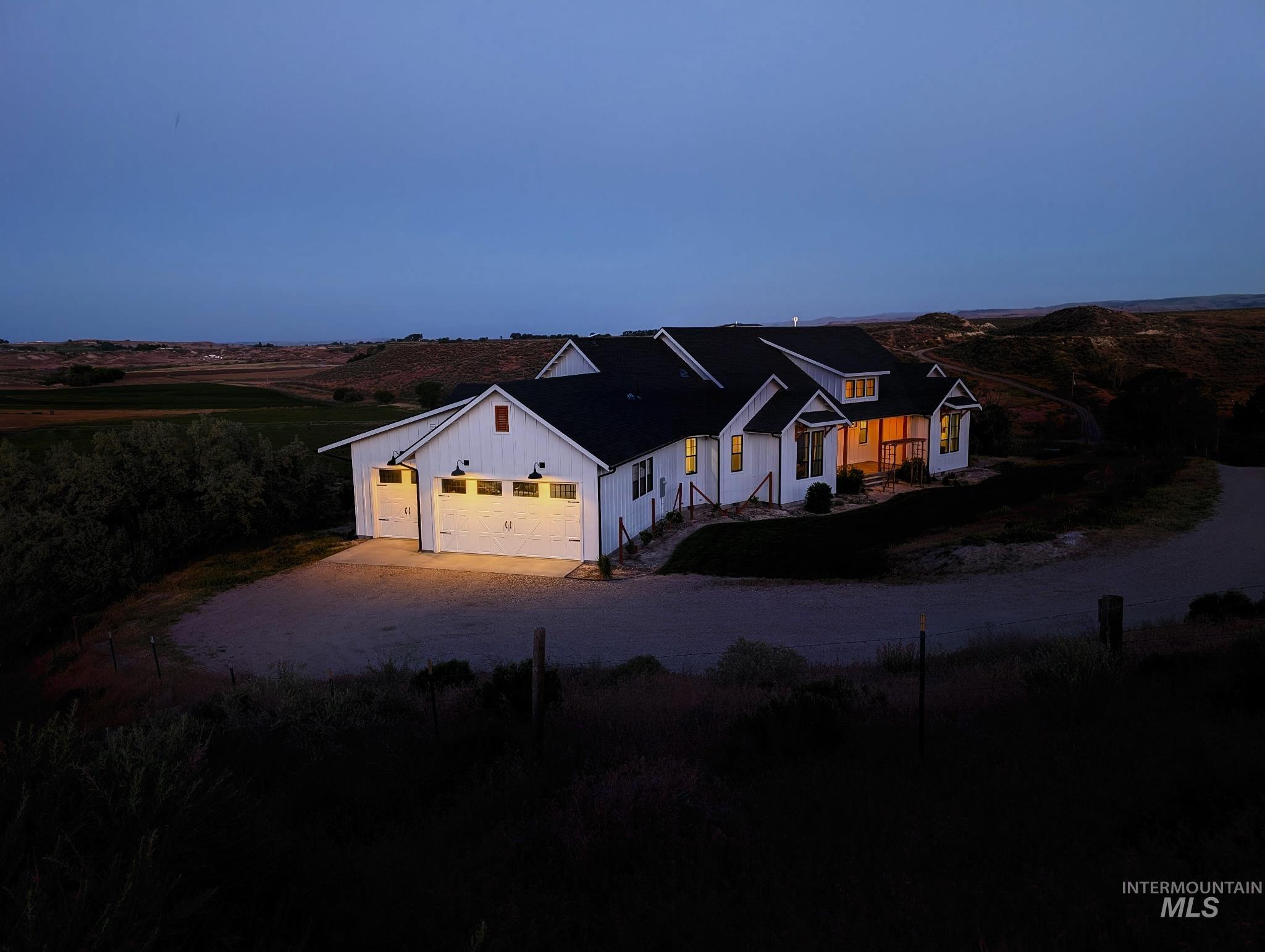 876 Coyote Gulch Road Adrian, OR 97901 - Photo 3 of 50 White farmhouse-style exterior with black trim and a dark roof