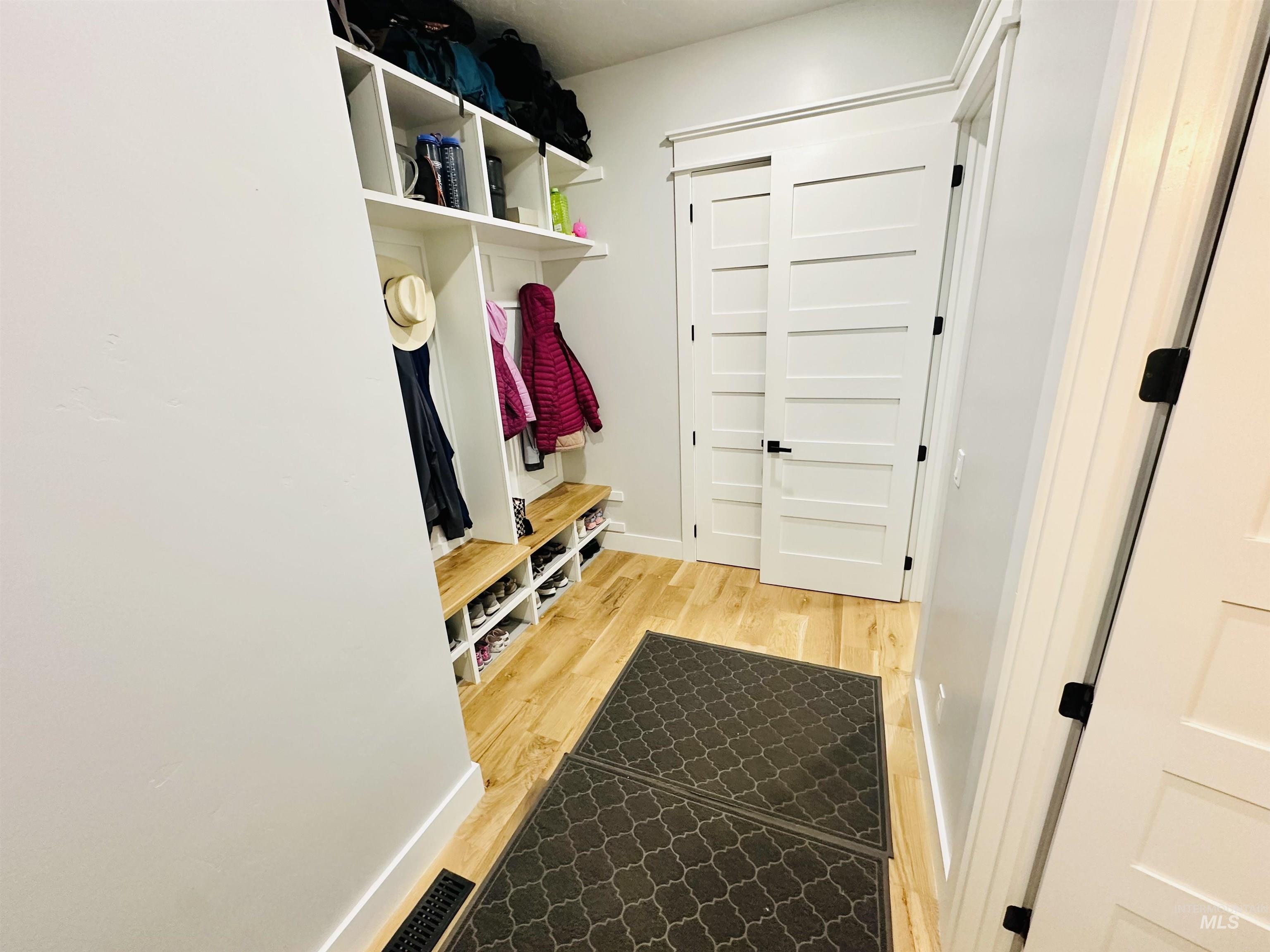 876 Coyote Gulch Road Adrian, OR 97901 - Photo 32 of 50 Built-in white cubby storage with natural wood-finish bench seating and integrated shoe compartments