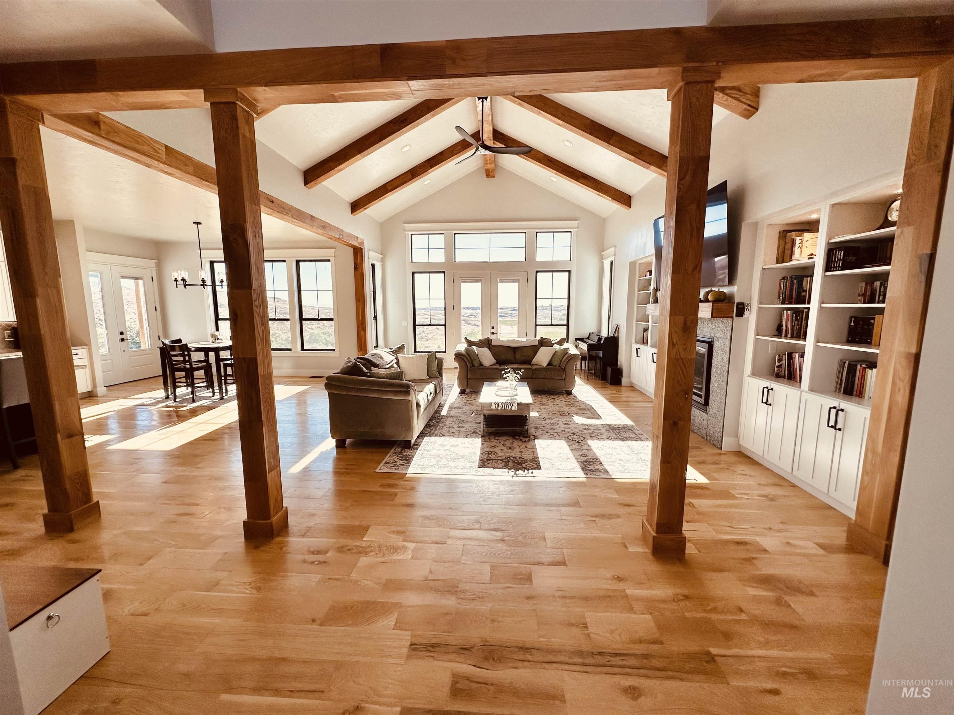 876 Coyote Gulch Road Adrian, OR 97901 - Photo 6 of 50 Spacious living area featuring exposed wood beams, vaulted ceilings, and light wood-finish flooring