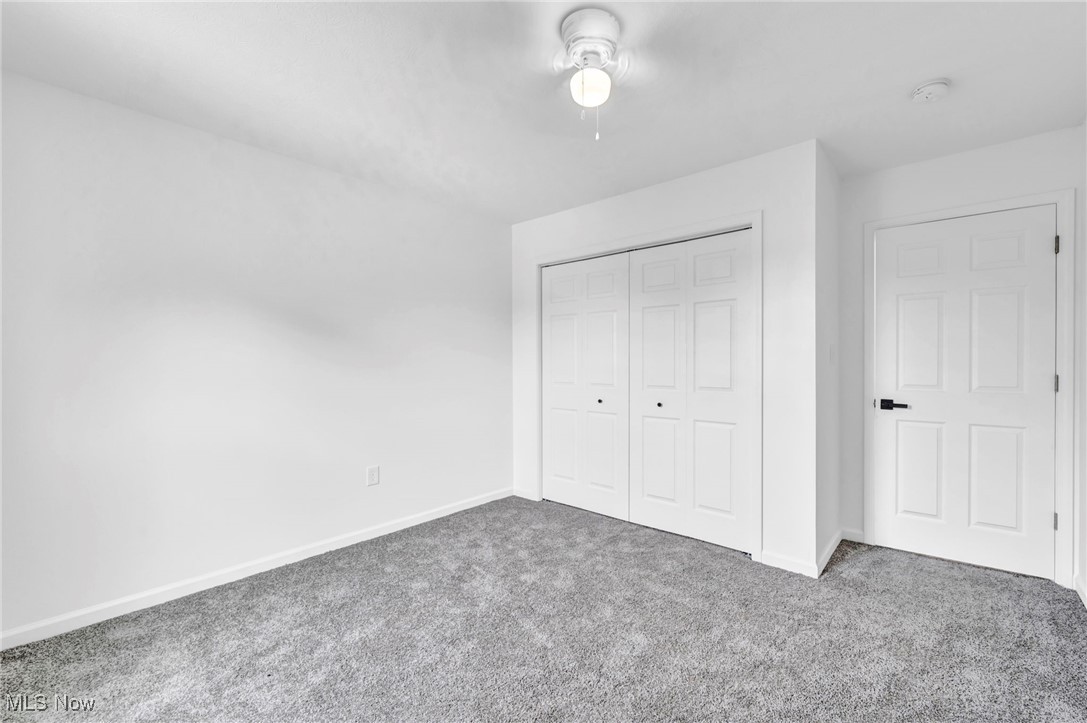 3709 Sudbury Road Cleveland, OH 44120 - Photo 22 of 29 Unfurnished bedroom with a closet, ceiling fan, and carpet floors