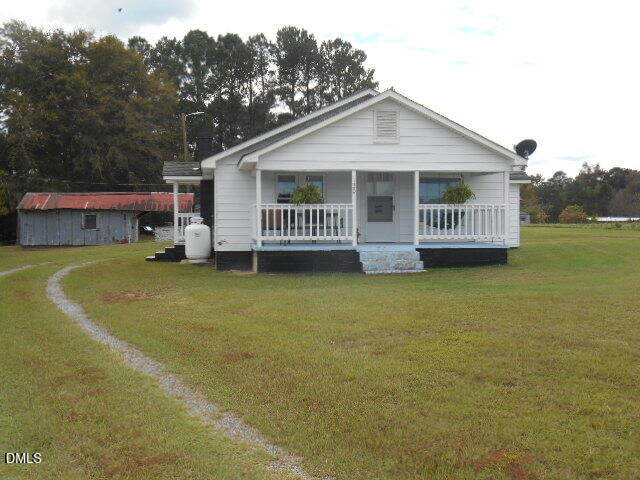 130 Holland Road Angier, NC 27501 - Photo 10 of 22 a view of a house with a backyard and deck