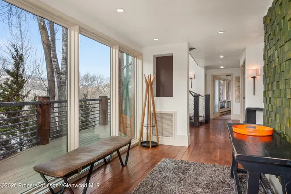 a living room with furniture a rug and a large window