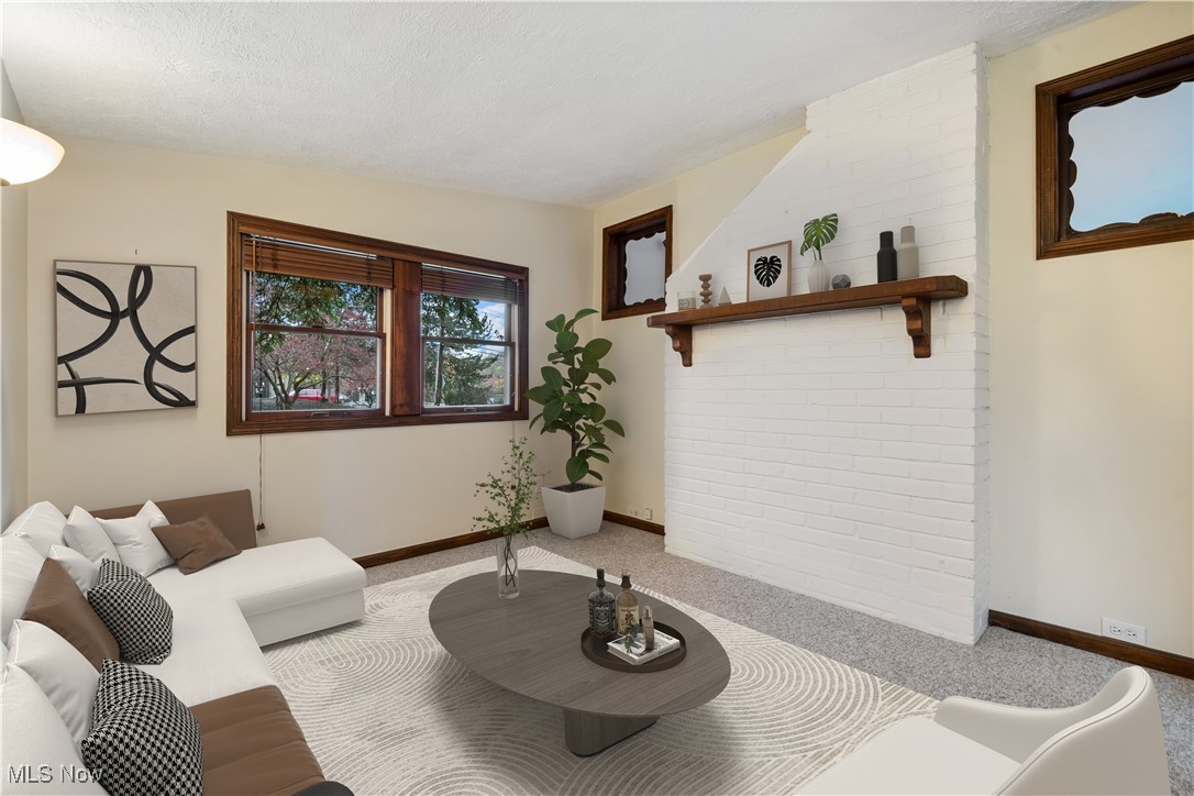 4488 Rainbow Road Cleveland, OH 44121 - Photo 15 of 39 Living room with light colored carpet and a textured ceiling