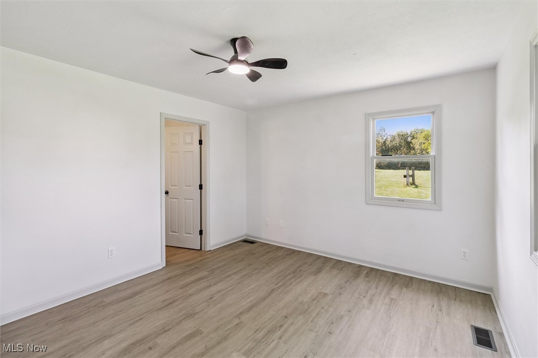 3930 Wood Road Madison, OH 44057 - Photo 36 of 45 Spare room with light wood-style flooring and ceiling fan