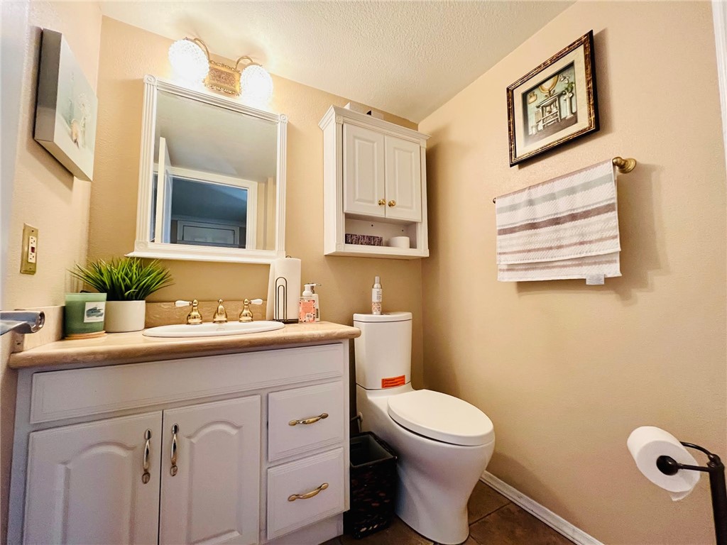 21945 Centurion Way Saugus, CA 91350 - Photo 7 of 25 a bathroom with a toilet a sink and mirror