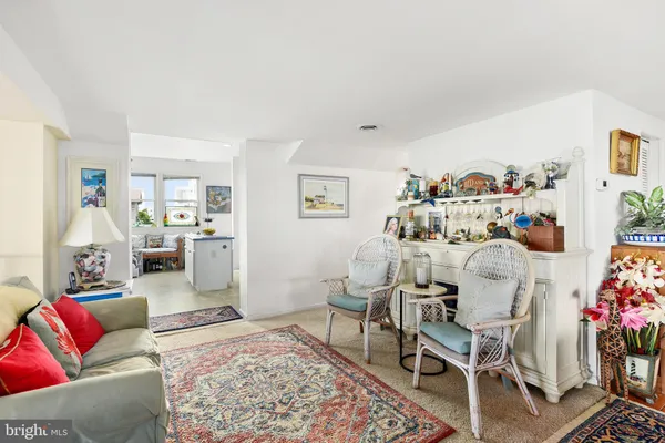 a living room with furniture and flowers