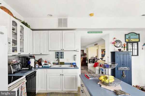 a kitchen with stainless steel appliances granite countertop a sink dishwasher stove and cabinets