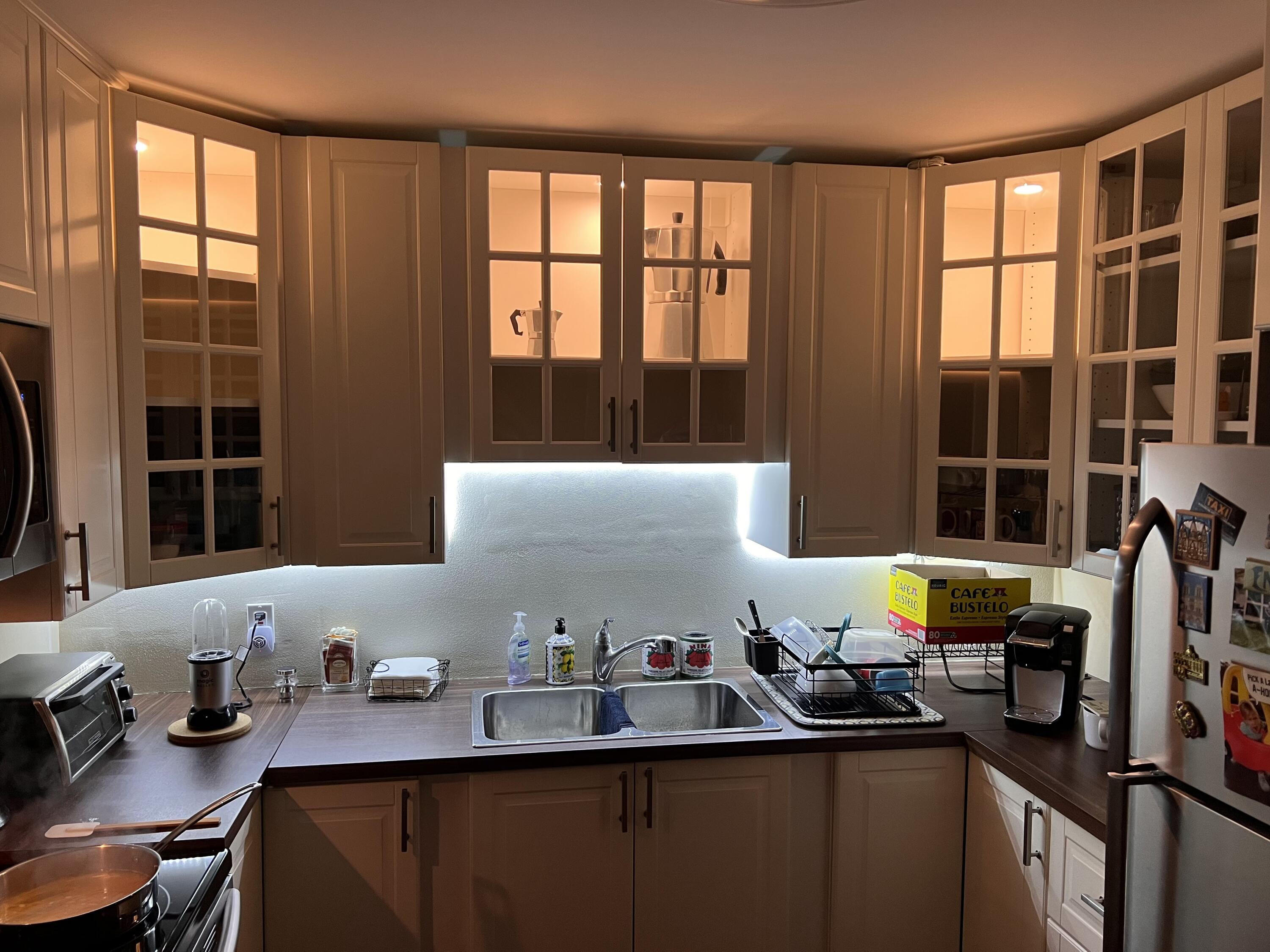 a kitchen with a sink cabinets and window