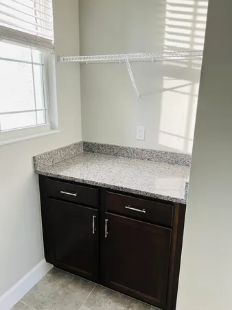 a bathroom with a granite countertop double vanity sink and a mirror