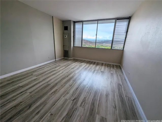 wooden floor in an empty room with a window