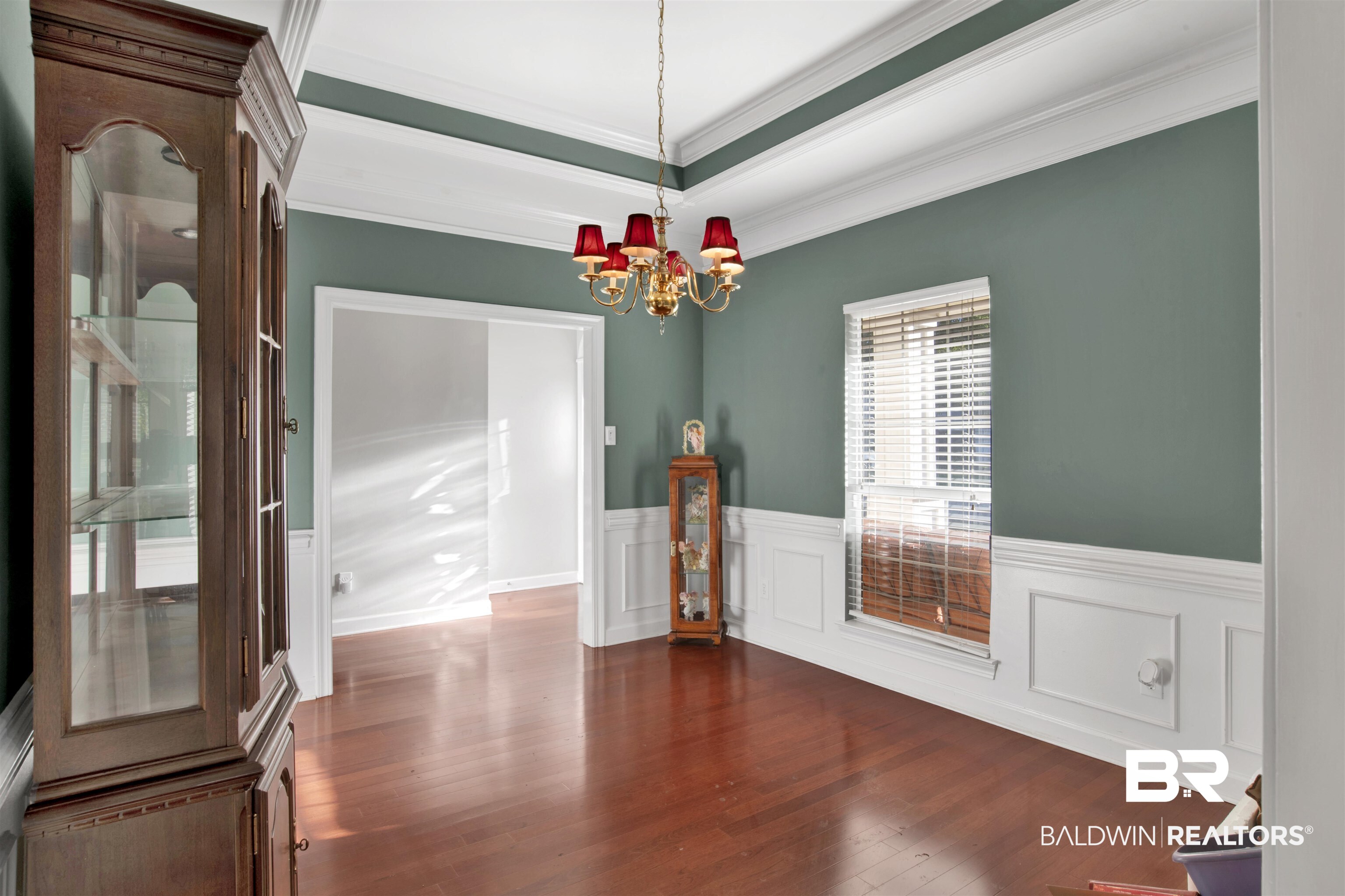 445 Wedgefield Drive South Mobile, AL 36608 - Photo 6 of 36 Unfurnished dining area with dark hardwood / wood-style flooring, crown molding, and a notable chandelier