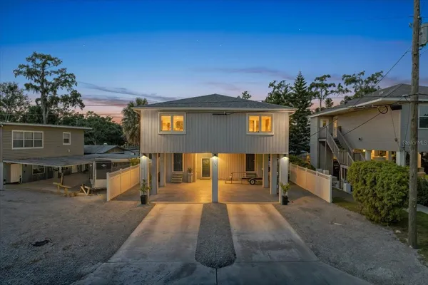 a front view of a house with a yard and a garage