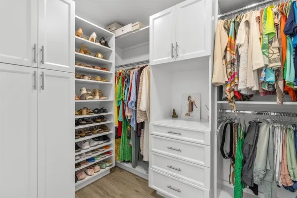 a bedroom with a bed window and dresser