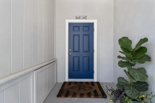 a living room with furniture kitchen view and a chandelier