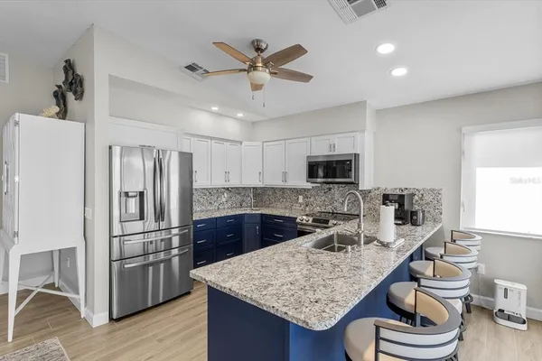 a kitchen with granite countertop a stove and a sink