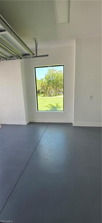 563 15th Street Northwest Naples, FL 34120 - Photo 21 of 22 an empty room with a fireplace and a window