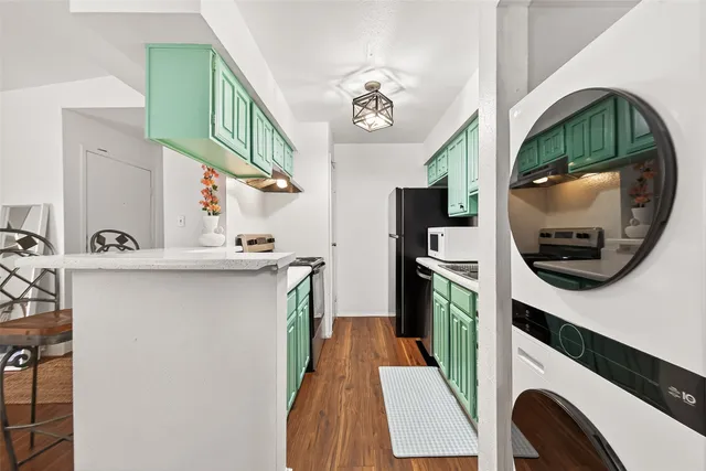 a bathroom with a sink a washer and dryer
