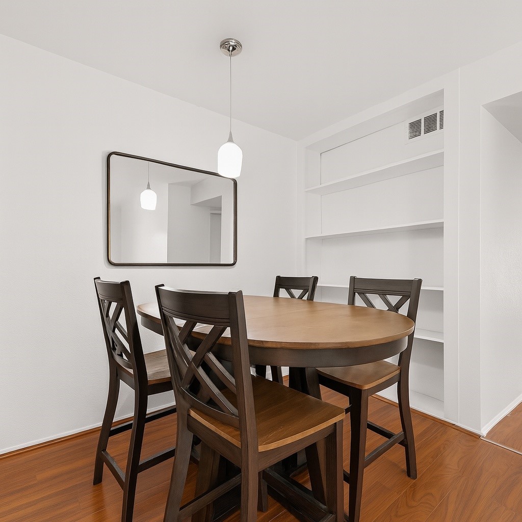 6001 Reims Road, Unit 908 Houston, TX 77036 - Photo 13 of 31 a view of a dining room with furniture and wooden floor